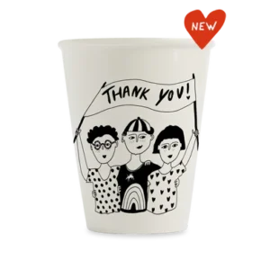The Faces Cup is a white mug with a black line drawing of three people holding a "Thank you!" banner. A red heart-shaped label marked "NEW" highlights this charming piece inspired by Estonian design. Gate21.ee