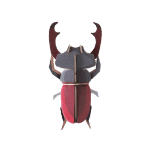 A StudioROOF Stag Beetle paper model featuring geometric shapes in red, grey, and black tones, photographed against a plain white background. Gate21.ee