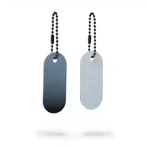 Two oval-shaped Reflective Tag - Black Fade keyrings with ball chains are shown—ideal for gifting or Tallinn shopping. One is solid black, the other grey with a grid pattern; both have a top hole for chain attachment, displayed on a white background. Gate21.ee