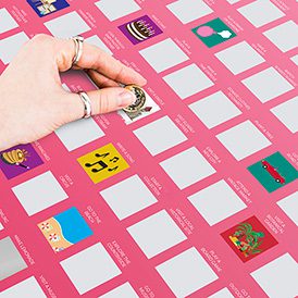 A hand with rings scratches off a silver square on the pink "100 Things to do with Dad - Bucket List" poster. Colourful illustrated boxes and icons are revealed, making it perfect for discovering unique bonding activities. Gate21.ee