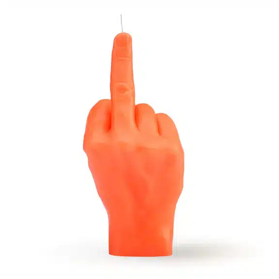 The F*ck You Candle - Neon Orange is shaped like a realistic hand giving the finger, perfect for concept shop displays or anyone seeking unique décor ideas. Shown against a plain white background. Gate21.ee