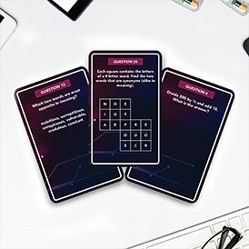 Three IQ Test Trivia – Card Game cards rest on a white surface, each showing unique questions and puzzles. Featuring Estonian design with black backgrounds and purple accents, the scene includes visible electronic device parts nearby. Gate21.ee
