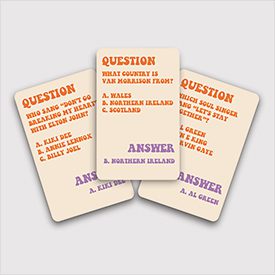 Three Groovy 70s Trivia - Card Game cards are shown, each displaying questions and multiple-choice answers in orange and purple. The centre card asks for Van Morrison’s home country, with Northern Ireland as the correct answer. Gate21.ee