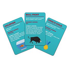 Three cards from "100 Things you thought you Knew Trivia - Card Game"—GOLDFISH, BULL FIGHT, and FOOLS GOLD—are shown. Each displays a question, multiple choices, and a brief explanation on a teal background. Gate21.ee