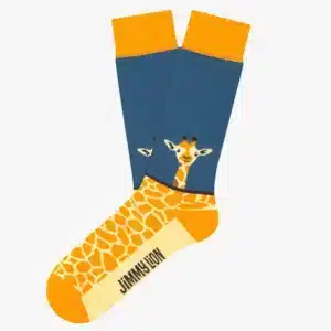 The Giraffe - Regular socks feature orange and yellow giraffe print on the foot, a blue upper with a giraffe’s head, and the Jimmy Lion logo on the sole—making them a standout, stylish Tallinn shopping choice. Gate21.ee