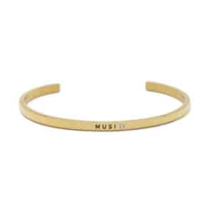 The Musi bracelet is a sleek, open-ended gold piece with "MUSI" and a small gemstone on the front, showcasing curated Estonian design—an ideal addition to any gift shop collection. Gate21.ee
