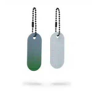 The Reflective Tag - Green Fade set includes two oval metal tags on beaded chains: the left tag transitions from green to grey, while the right is light grey with a subtle grid, both displayed on a white background. Gate21.ee