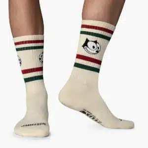 Cream-coloured FELIX Smile - Athletic socks with red and green stripes and a cartoon cat face design, as seen in Tallinn shopping guides. Black text and symbols decorate the soles, all photographed on a plain white background. Playful style!. Gate21.ee