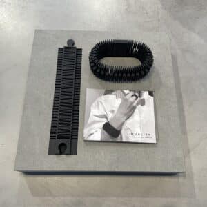 A black ribbed Bracelet - DUALITY - K&Otilde;IK, a matching flat piece, and a booklet titled DUALITY are arranged on a grey surface&mdash;showcasing Tallinn concept store style. Gate21.ee