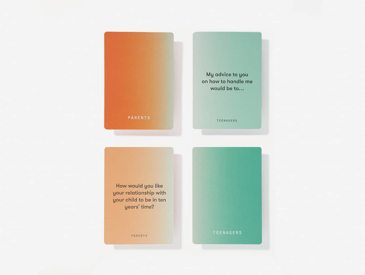 The Parents & Teenagers Game features orange "PARENTS" and green "TEENAGERS" cards, each with a curated prompt—reminiscent of finds from an Estonian design gift shop—arranged in a four-card grid. Gate21.ee