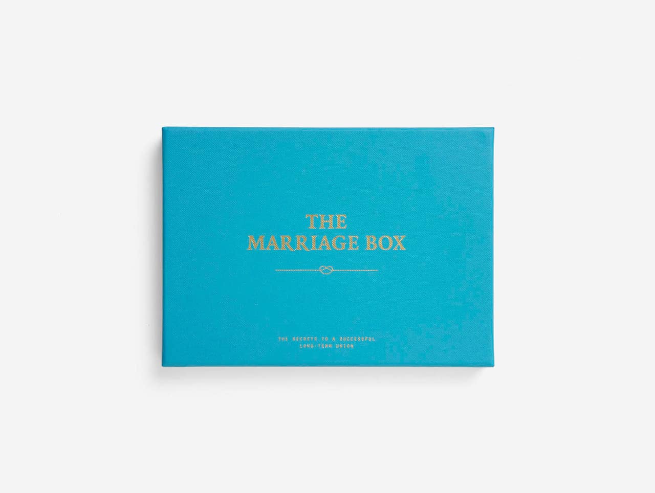 A rectangular turquoise box with gold text on the lid reading "Parents & Teenagers Game." Perfect for Tallinn shopping or as a local gift shop find, it features a smaller, partially legible gold line below on a plain white background. Gate21.ee