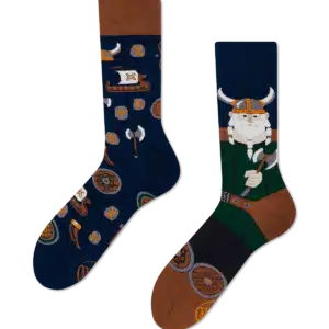 Fisher's Tale socks feature Estonian-inspired designs: one with Viking helmets, axes, and shields on navy, the other with a green and brown cartoon Viking—ideal Tallinn souvenirs from your favourite concept shop. Gate21.ee