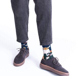 A person wears Fisher's Tale corduroy trousers, brown lace-up shoes, and cat-print socks—ideal for unique gift ideas or Estonian design inspiration whilst shopping in Tallinn. Image is cropped at the waist; only lower legs and feet appear. Gate21.ee