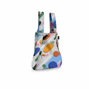 The Fruit Salad - Notabag is a reusable shopping bag with two handles, featuring a vibrant geometric pattern in blue, orange, green, and purple on white—ideal for Tallinn shopping or discovering unique finds at concept shops. Gate21.ee