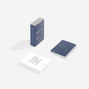 A blue box labelled Meaning of Life Cards, featuring Estonian design, holds carefully curated blue and white cards. The top white card asks: WHO WOULD YOU CHOOSE TO CHALLENGE YOURSELF?. Gate21.ee