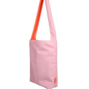 A Feel Good Bag - Pink Dolphin by Tinne+mia, featuring a pink rectangular shape, a long strap, and an orange interior, is displayed standing upright against a plain white background. Gate21.ee