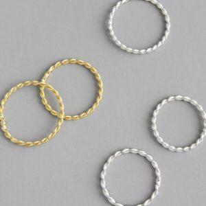 ZEN 925 Sterling Silver - Earrings feature a rope-like texture and showcase Estonian design. These simple pieces are perfect to discover at a Tallinn shopping concept store, displayed on a grey surface for an elegant look. Gate21.ee
