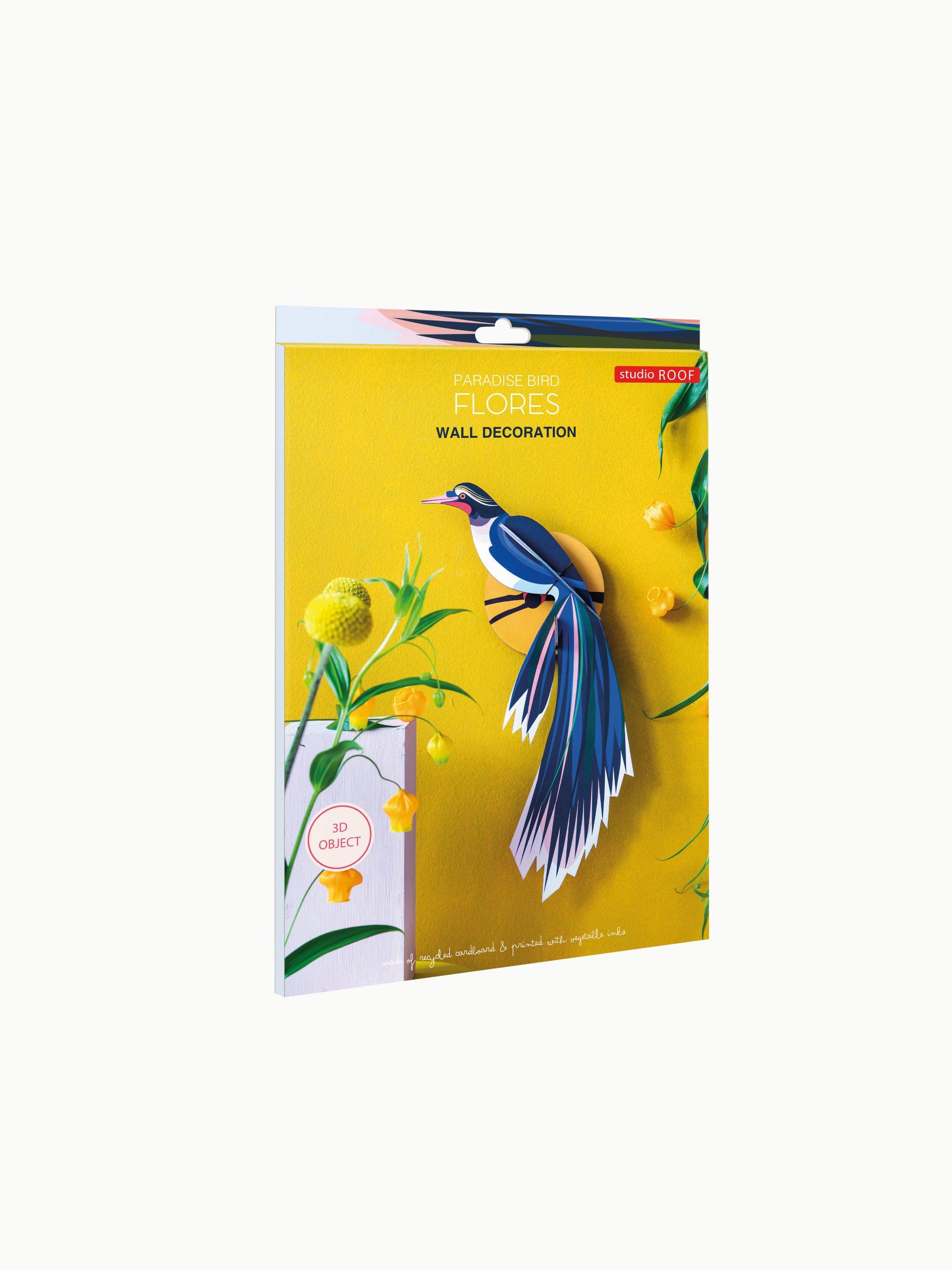 The Paradise Bird Flores by Studio ROOF features a blue and white paradise bird with long tail feathers, set on a yellow background with green stems and yellow flowers—an ideal wall decoration for unique gift shop ideas. Gate21.ee