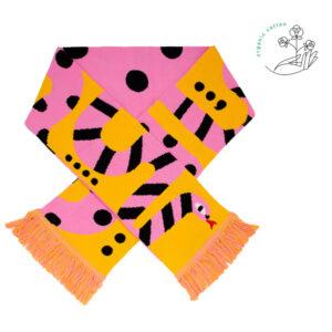 The Snake - Organic scarf features a yellow and pink snake design with black stripes and dots, pink fringes, and a white background. Finished with an organic cotton icon—ideal for curated gift shops or concept stores. Gate21.ee