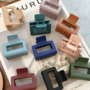 Nine ZEN LARGE Hair Claws - K&Otilde;IK in assorted colours are arranged on an open magazine, square-edged design displayed neatly in three rows, ideal for Tallinn shopping or discovering unique finds at your favourite gift shop. Gate21.ee