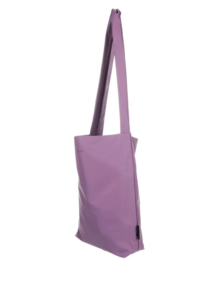The Feel Good Bag - Pale Pansy is a lavender, rectangular tote with a single wide strap and curated Estonian design, displayed against a plain white background. Gate21.ee