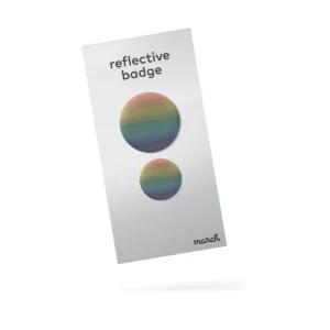 A white card labelled “Double - 7 Colours” showcases two round, rainbow-gradient reflective badges—one large and one small—with “march” printed in the bottom right corner. Gate21.ee