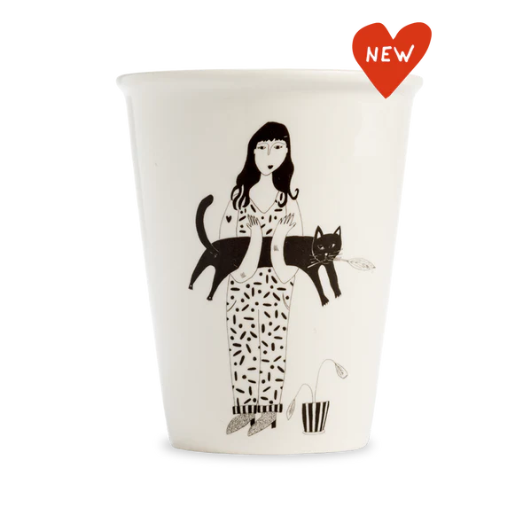 The Black Cat Cups feature a black and white illustration of a woman holding a cat, beside a small potted plant. Accented with a red "NEW" heart label—an ideal pick for gift shops looking for unique finds. Gate21.ee