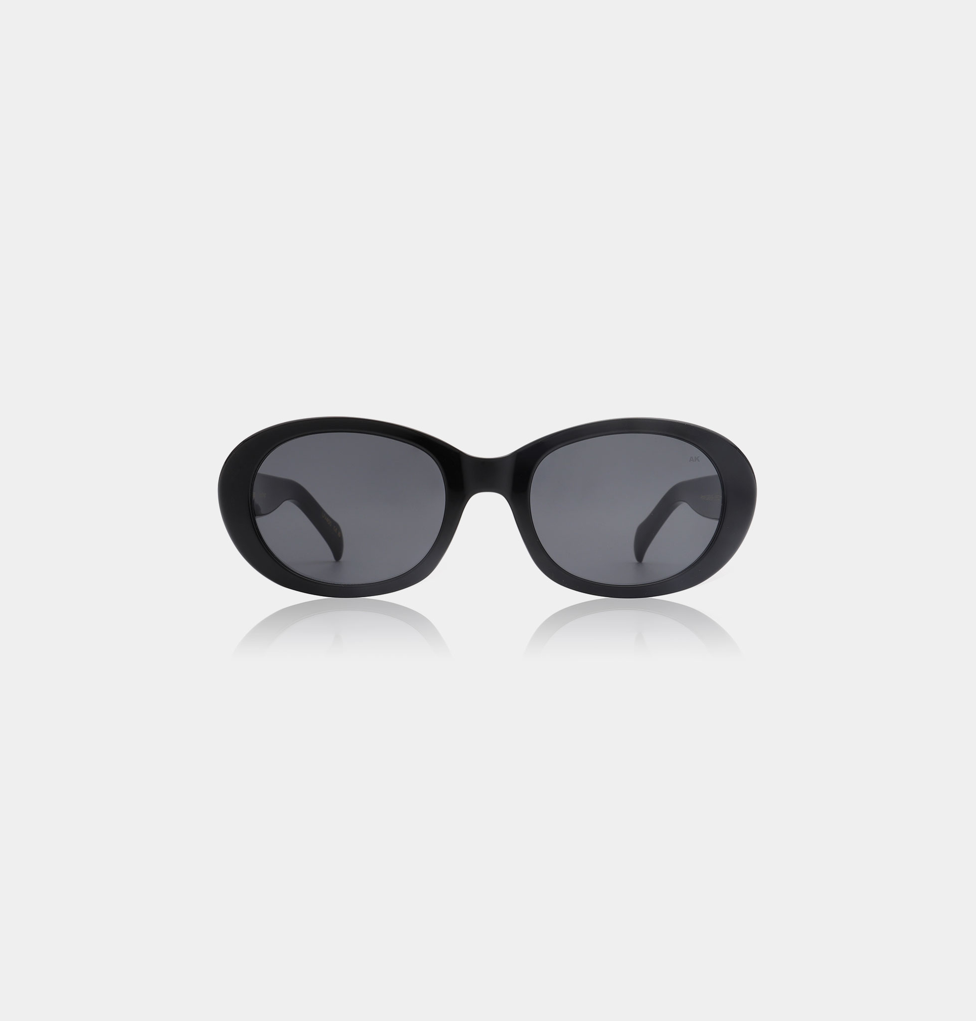 ANMA - Black oversized sunglasses with rounded frames and dark lenses, shown on a plain white background. Curved arms add comfort—an ideal standout accessory for gift shops seeking unique Estonian design. Gate21.ee