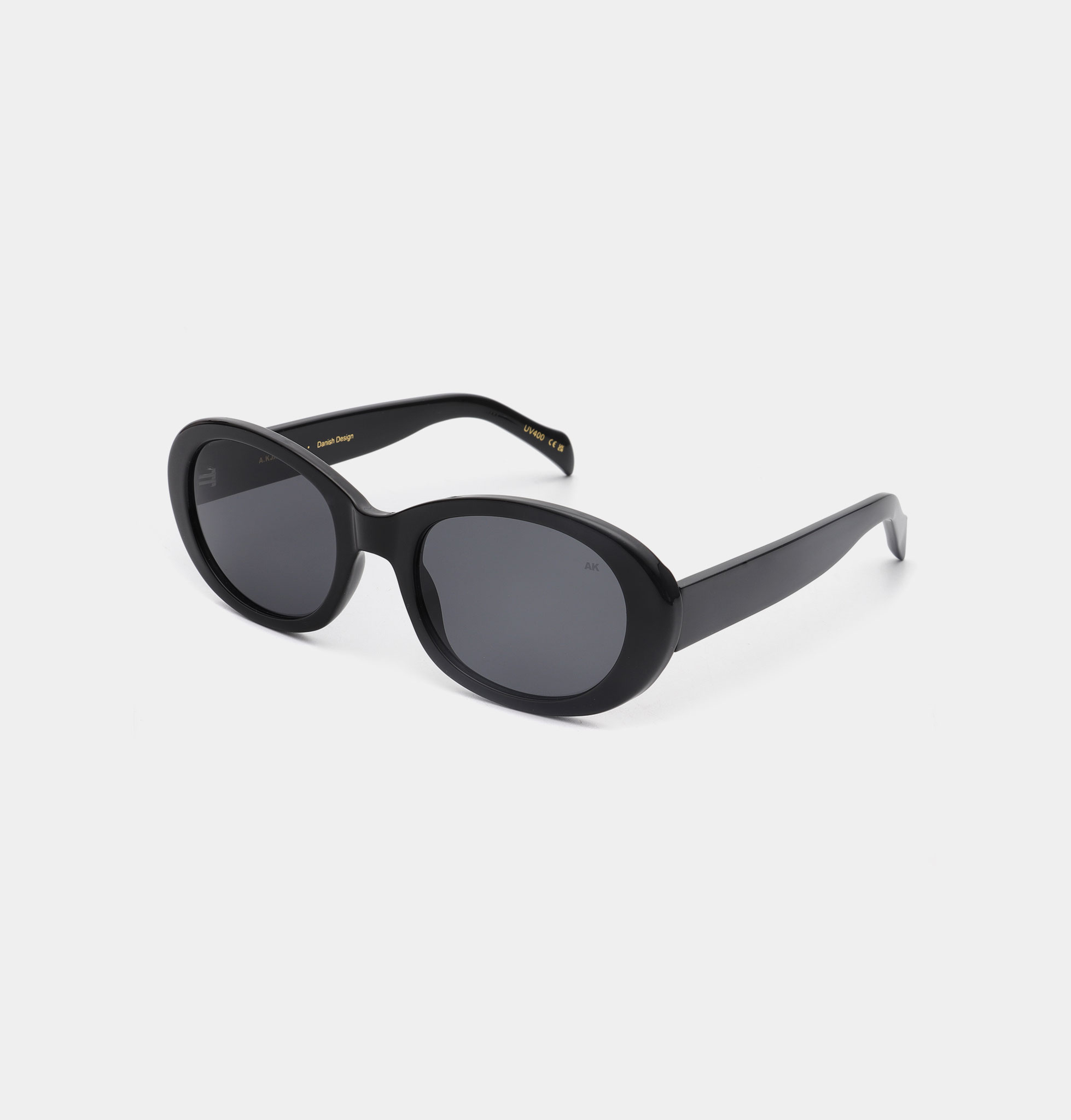 ANMA - Black: Sleek black oval sunglasses with dark lenses, showcased at a three-quarter angle on a plain white background—Estonian-inspired and ideal for any concept shop collection. Gate21.ee