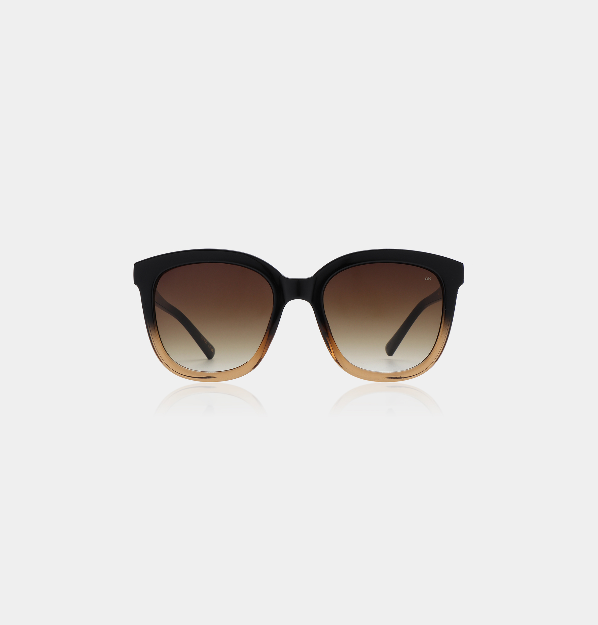 The BILLY - Black Brown Transparent sunglasses feature black frames fading into brown at the bottom and brown gradient lenses, ideal for unique style on your Tallinn shopping trip, shown against a plain white background. Gate21.ee