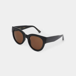 The LILLY - Black sunglasses feature bold cat-eye frames in black with brown-tinted lenses, making them a striking accessory for anyone seeking distinctive style. Displayed on a plain white background. Gate21.ee