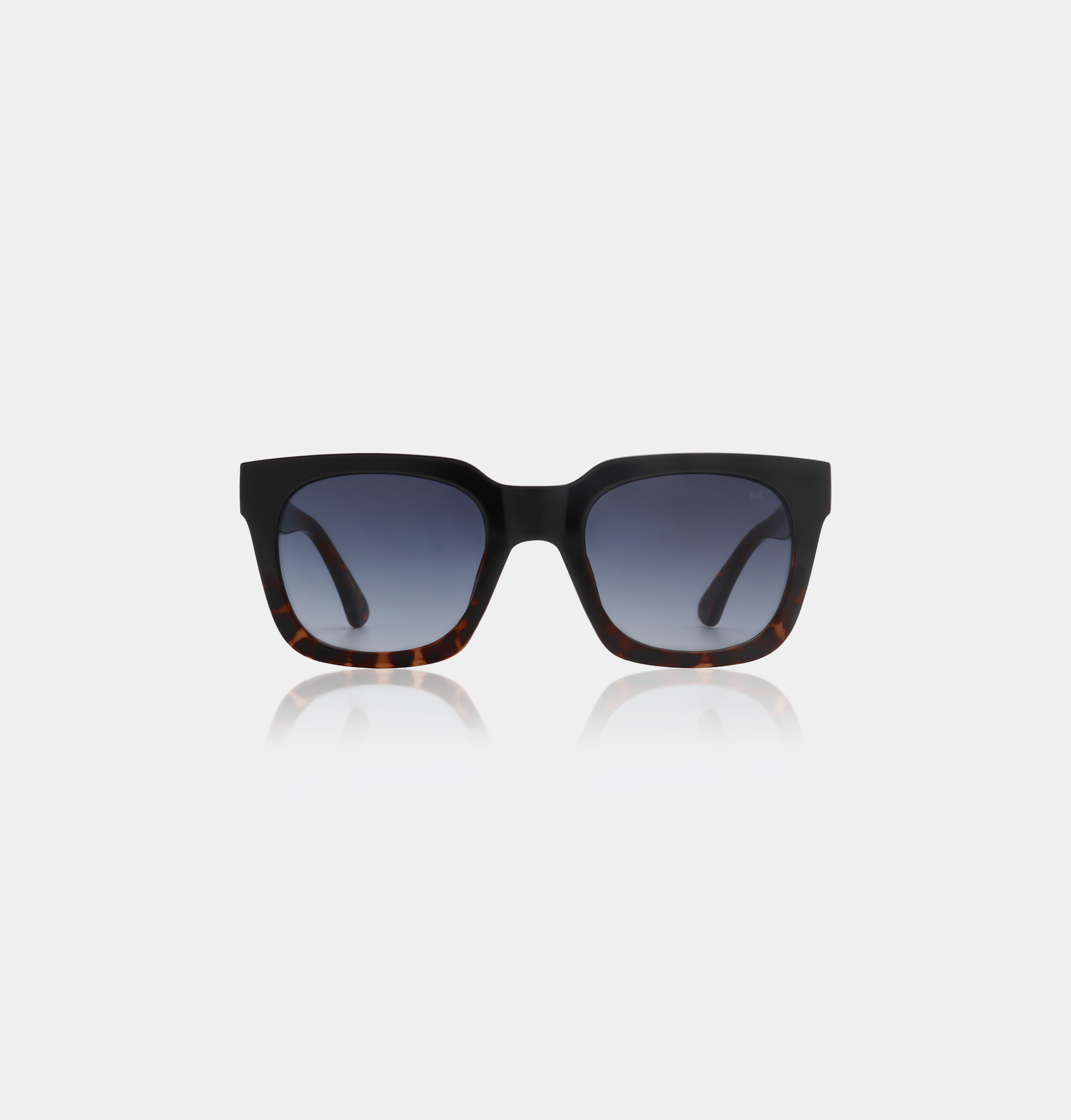 The NANCY - Black Demi Tortoiseshell sunglasses feature square frames in black and tortoiseshell with dark gradient lenses, ideal for trying new styles at a Tallinn concept shop. Shown against a plain white background. Gate21.ee