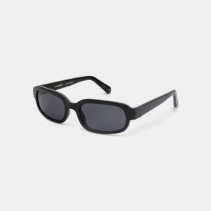 The WILL - Black sunglasses feature thick black oval frames, dark lenses, and subtle gold text on the inner temples. Inspired by Estonian design, they make a unique gift shop find and are shown on a plain white background. Gate21.ee