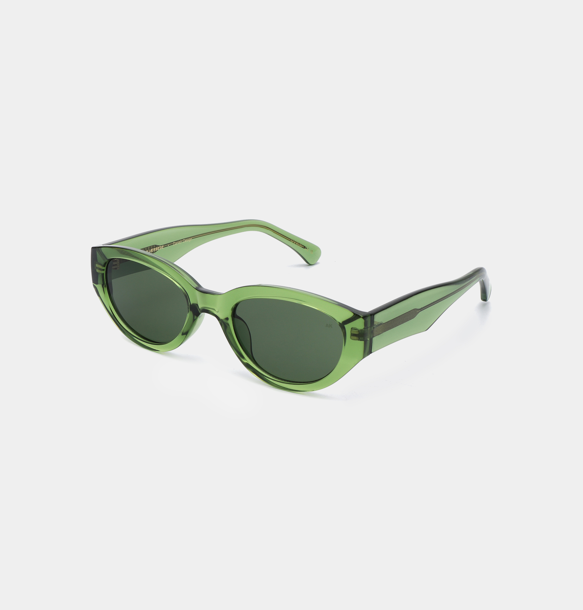 The WINNIE - Light Olive Transparent sunglasses feature a green, cat-eye shape with dark lenses and thick, translucent frames, showcasing Estonian design, displayed against a plain white background. Gate21.ee