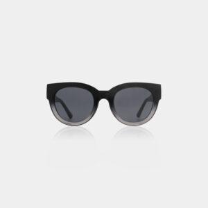 The LILLY - Black/Grey transparent sunglasses feature a round silhouette and dark lenses, standing upright against a plain white background, showcasing the clean lines and minimalist elegance of Estonian design. Gate21.ee