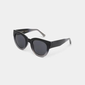 The LILLY - Black/Grey transparent sunglasses feature a curated cat-eye design with dark lenses and thick, angled arms, shown on a plain white background—a chic accessory inspired by Tallinn shopping and unique ideas. Gate21.ee