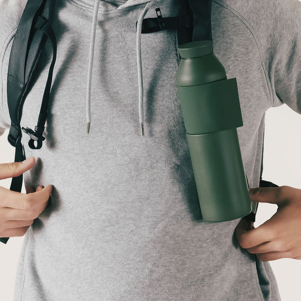 Wearing a light grey hoodie and black rucksack with a Closca Wave Large - Amazonia 600ml water bottle attached, someone explores curated Tallinn shopping spots or hunts for treasures in a local gift shop. Gate21.ee