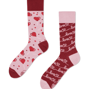 Love Story features two mismatched socks: one pink with red hearts and polka dots; the other red with pink "love" text and hearts in lines. Both have red toes, heels, and cuffs—a fun, uniquely designed gift. Gate21.ee