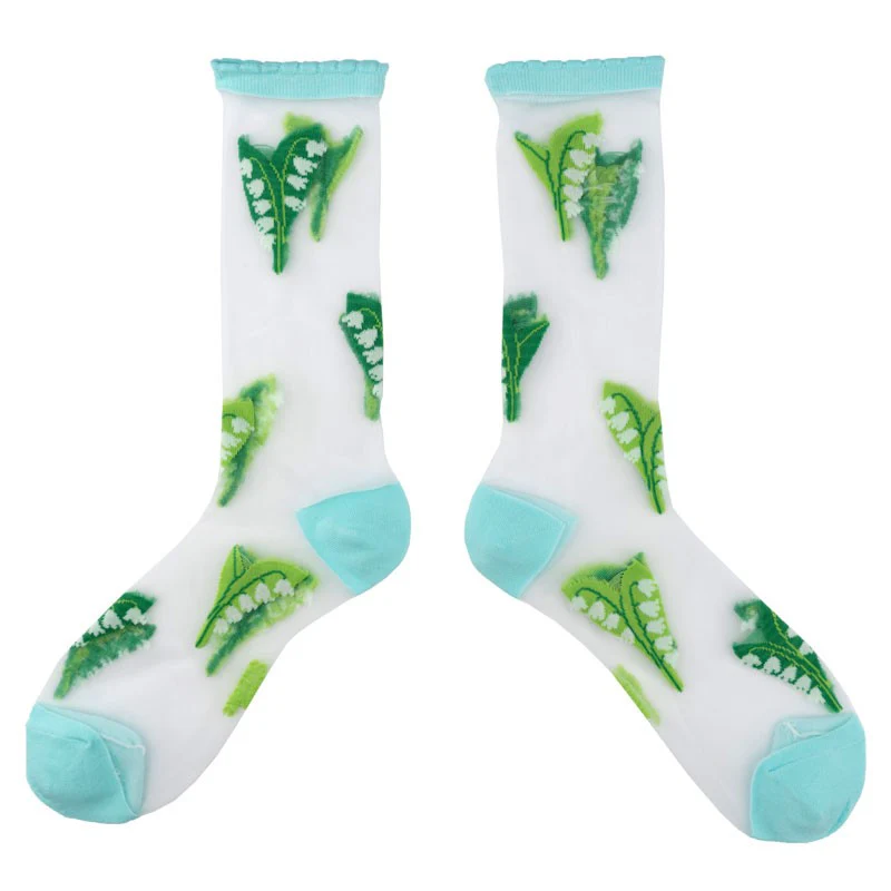 Lily of the Valley - Transparent Socks: White socks with light blue toes, heels, and cuffs, featuring an Estonian-inspired green pea pod pattern—ideal for unique gift shop finds. Gate21.ee
