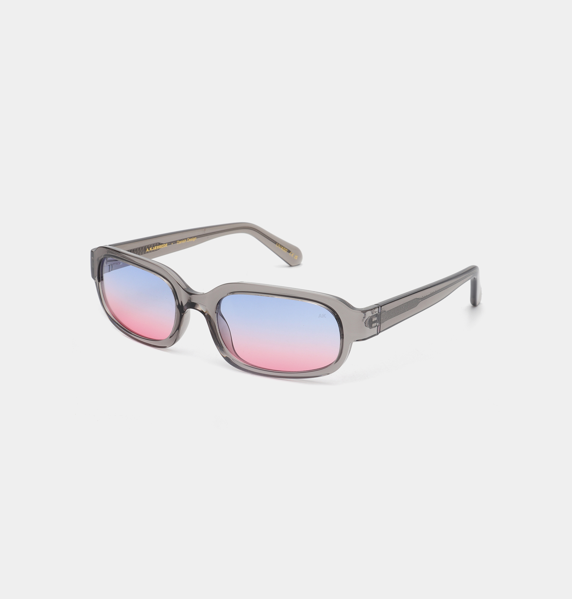WILL - Grey Transparent: Rectangular sunglasses featuring translucent grey frames and gradient lenses fading from pink (bottom) to blue (top), reflecting sleek Estonian design, displayed on a white background. Gate21.ee