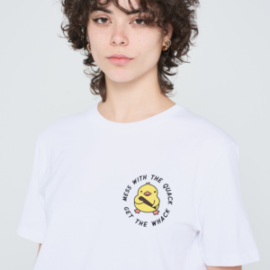 A person with short, curly brown hair wears a pink Love Me Worm T-shirt featuring a cartoon duck and the text “MESS WITH THE QUACK GET THE WHACK” printed on the front. The background is plain light grey. Gate21.ee