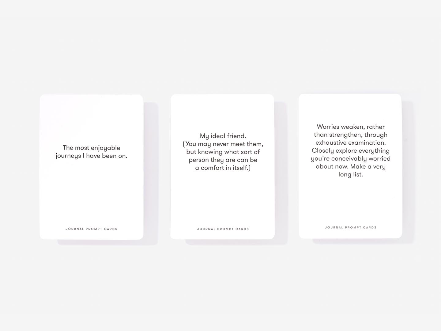 Three Journal Prompt Cards, each featuring black text on white, are displayed in a row. This curated set offers reflective prompts on journeys, ideal friends, and worries—thoughtful gifts for any Tallinn shopping or gift shop visit. Gate21.ee