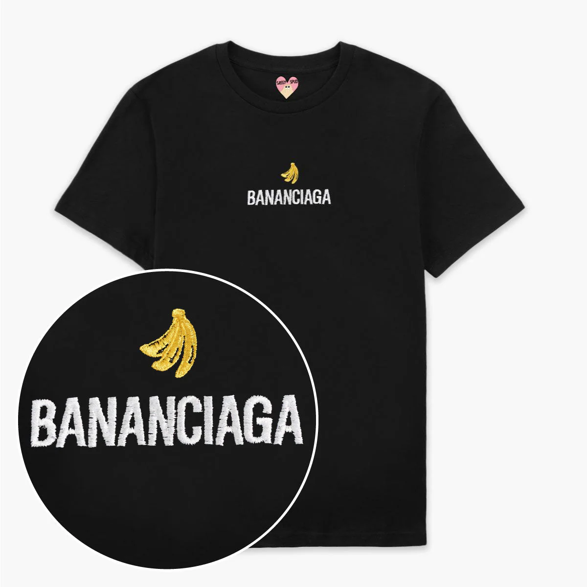 The Bananciaga Embroidered T-Shirt - Black features white "BANANCIAGA" text with a yellow banana above it. A close-up inset highlights the embroidery—perfect for concept shops or gift shop displays and fans of Estonian design. Gate21.ee