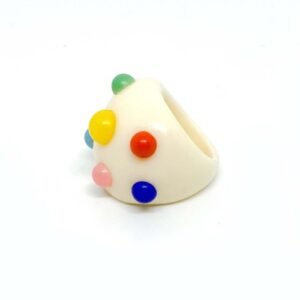 The Spring Dragon Fruit - Ring features a chunky white band adorned with raised dots in green, yellow, red, pink, blue, and orange—a playful Estonian design ideal for curated gift shops. Shown on a plain white background. Gate21.ee
