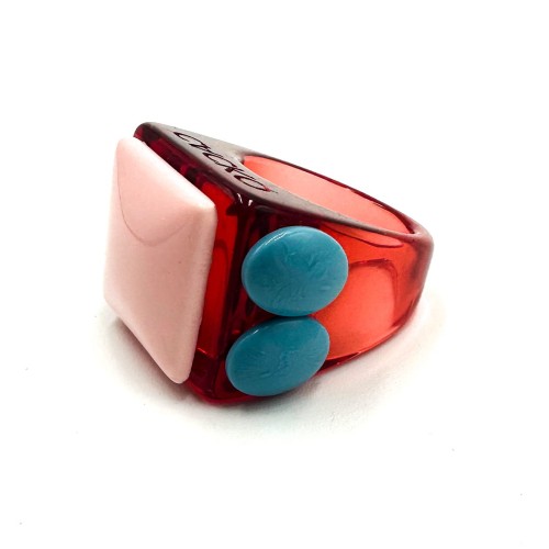 The Waleria - Ring features Estonian design with a chunky red translucent band, large pale pink rectangular top, and two blue side buttons—an eye-catching piece for Tallinn shopping or unique concept shop collections. Gate21.ee