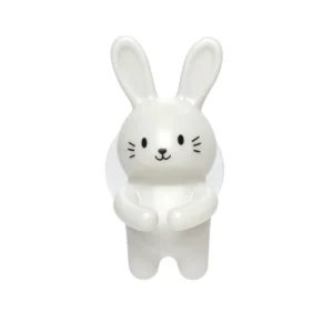The Rabbit - Toothbrush Holder is a small, white, plastic figure standing upright with classic long ears and whiskers—an Estonian design perfect for Tallinn gift shop lovers or anyone seeking a charming bathroom accessory. Gate21.ee