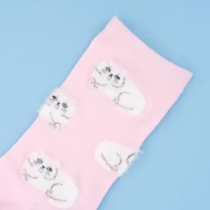 A close-up of Persian Cats - Pink Cotton Socks featuring white fluffy cats outlined in grey with black facial features on a solid light blue background—an ideal whimsical addition to any curated gift shop or concept store. Gate21.ee