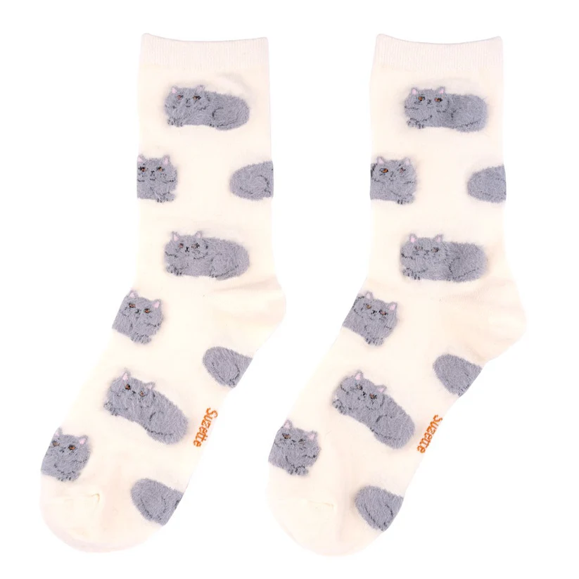 Persian Cats - White Cotton Socks: Cream socks with a repeating pattern of grey cats lying down, inspired by Estonian design. "Soxsies" is written in orange near the toes. Gate21.ee