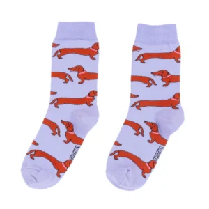 Add a playful accent to your wardrobe with Dachshund - Cotton Socks, featuring light purple fabric adorned with a fun red dachshund pattern—perfect for gifting or treating yourself. Gate21.ee