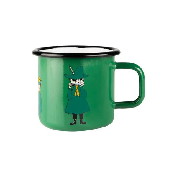 The Snufkin - Moomin green enamel mug 3.7dl has a black rim and features Snufkin in a green coat and hat playing harmonica, with other characters partly visible—a charming Estonian design, ideal for gift shops. Gate21.ee